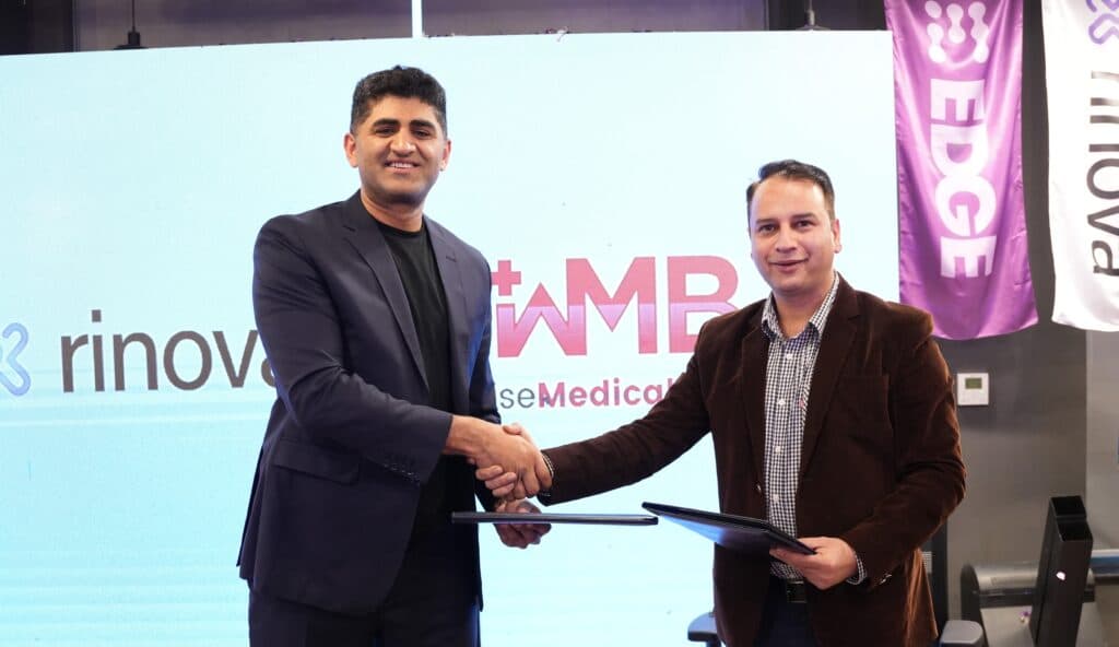 Representatives of Rinova AI and Wise Medical Billing shake hands at the partnership announcement